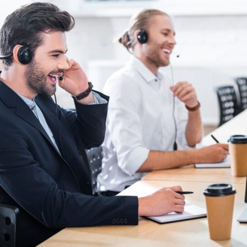 side-view-of-male-call-center-operators-in-headsets-at-workplace-in-office-1-1024x684